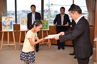 写真：市長から表彰状を受け取る近藤さん