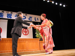 市長から記念品を受け取る新井麻友香さん