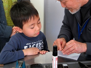 写真：講師から作り方を教わる子ども