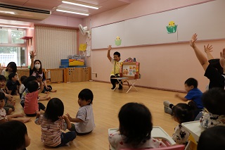 ヤクルトのお姉さんが読んでいる紙芝居を子ども達がみている