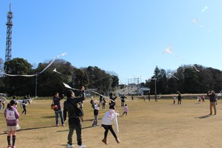 広場でたこあげをする親子たち