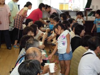 ゴーヤ茶を配る子どもたちの写真