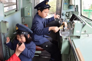 運転席にすわる子どもたちの写真