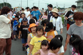 暑い中元気に神輿を担ぐ子どもたち